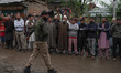 Indian security forces remain alert during the funeral of Ashiq Hussain, a policeman kille...