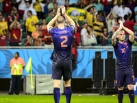 Netherland's Ron Vlaar (L) and Wesley Snijder salute the crowd after the end of the #3 2014 World Cup match between Spain and Netherlands, i...