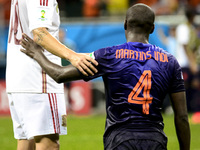 Spain's Cesc Fabregas (L) talks with Netherland's Bruno Martins Indi after the end of the #3 2014 World Cup match between Spain and Netherla...