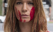 Activists from Animalia Naturalis are covered with fake blood during a protest in Madrid o...