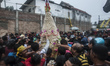 People scramble bakpia during event Bakpia Carnival walk in Yogyakarta, Indonesia, on Sept...