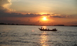 People ride on a boat at sunset over Padma River outskirts of Dhaka, Bangladesh on Septemb...