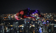 A base jumper leaps from the 300-metre (984 ft.) high open deck of Malaysia's landmark Kua...