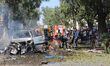 Firefighters work at an explosion site in Mogadishu, Somalia, on Oct. 1, 2016. At least fo...