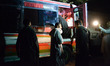 People inspect a damaged bus at the attack site in southwest Pakistan's Quetta on Oct. 4,...