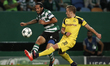 Sporting's midfielder Ezequiel Schelotto (L) vies for the ball with Dortmund's midfielder...