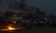 Fire burn in the Calais Jungle  in Calais, France, on 25 October 2016. Up to the evening,...