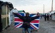 A Migrant poses in the Calais Jungle  in Calais, France, on 25 October 2016, with the UK F...