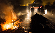Police officers stand in the Calais Jungle beside a fire engine  in Calais, France, on 25...