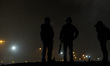 A Photographer takes photos in the Calais Jungle from two police officers  in Calais, Fran...