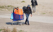 Migrants, carrying their luggage, during evacuation of the Calais 'Jungle' camp, in Calais...