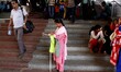  A married blind woman stands on the stair case of the entrance gate of the city railway s...