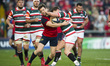 Darren Sweetnam of Munster fights for the ball with Freddie Burns of Leicester during the...