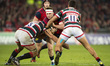 Rory Scannell of Munster tackled by Graham Kitchener and Peter Betham of Leicester during...