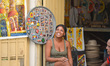 A vendor outside her shop with suvenirs and memorabilia for sale, awaiting costumers, in H...