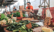 A local man at his stand selling fruits and vegetables in a  traditional market. A typical...