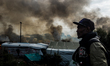 A Migrant looks in the in the Calais Jungle at the burning huts, on October 26, 2016. Huge...