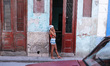 A young lady seen near her house entrance in Havana city center. For a week I explored th...