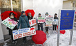 Human right activists and sex workers hold placards during a rally against violence agains...