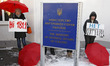 Human right activists and sex workers hold placards during a rally against violence agains...