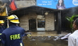 Bangladeshi firefighters try to douse flame after a fire broke out in a market at Gulshan,...