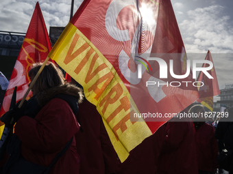 People hold French General Confederation of Labour (CGT) union's flags and a banner during an inter-union protest to alert on a plan of mass...