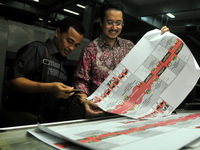 Commissioner General elections Indonesia Ferry Kurnia Rizkiyansyah (right) shows the ballots prepared for the provincial elections throughou...
