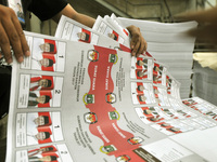 Workers print the ballot papers prepared for the provincial elections across the whole of Indonesia to come in a printing company in Pulogad...