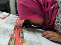 Printing worker checks ballot papers prepared for the provincial elections throughout Indonesia to come in a printing company in Pulogadung,...
