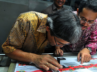 Commissioner General elections Indonesia Hadar Nafis Gumay (left) and Ferry Kurnia Rizkiyansyah (right) examine the ballots prepared for the...