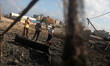 Palestinian inspect damages following an Israel airstrike in Gaza City, on July 3, 2014. I...