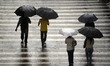 People walks during a rainfall in the Viaduct Chá, in the center of the city of Sao Paulo,...