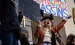 A demonstrator carries a sign during a rally in solidarity with supporters of the Women's...