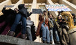 A demonstrator carries a sign during a rally in solidarity with supporters of the Women's...