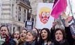 A demonstrator carries a sign during a rally in solidarity with supporters of the Women's...