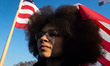 A demonstrator carries a sign during a rally in solidarity with supporters of the Women's...