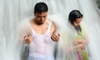 Balinese pray under the waterfall during the Banyu Pinaruh Day, in Genah Melukat Gunung Ka...