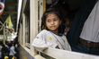Cambodian migrants arrive by train at Aranyapathet Railway Station in Thailand before cros...