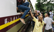 Cambodian migrants arrive by train at Aranyapathet Railway Station in Thailand before cros...