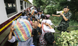 Cambodian migrants arrive by train at Aranyapathet Railway Station in Thailand before cros...