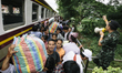 Cambodian migrants arrive by train at Aranyapathet Railway Station in Thailand before cros...