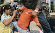Cambodian migrants are transferred to a holding area before crossign the border from Thail...