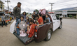 Cambodian migrants are transferred to a holding area before crossign the border from Thail...