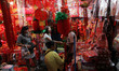 Indonesians Chinese ethnic purchase ornaments ahead of the Lunar New Year at a market stal...