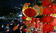 A rooster figure is displayed near Chinese lantern at a market stall in Jakarta, Indonesia...