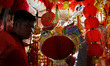 A rooster figure is displayed near Chinese lantern at a market stall in Jakarta, Indonesia...