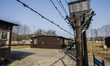 Barbed wire fence and watchtower are seen in former Nazi German Concentration Camp Stuttho...