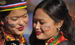 Girls in a traditional attire takes pictures from mobile phone during celebration of Sonam...