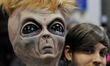 A alien with Trump wig is seen amid thousands who turned out for a January 29th, 2017 Immi...