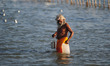 An indian sadh returns after carring holy water of ganges River in plastic container,water...